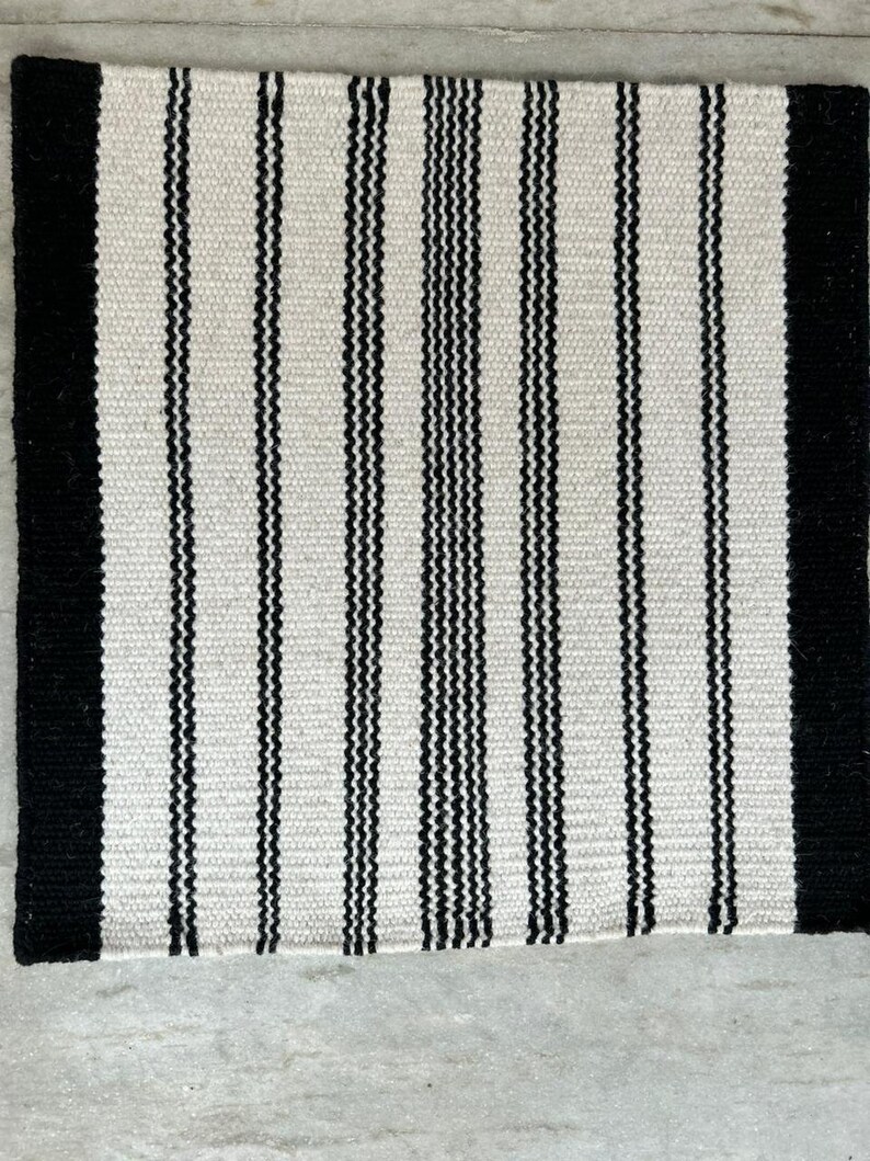 Black and white striped textile rug pattern