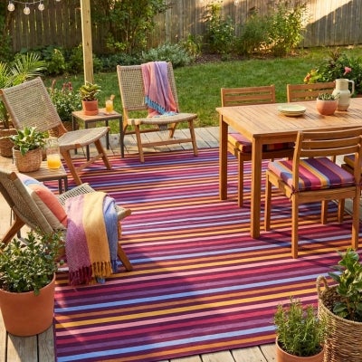 Colorful reversible outdoor rugs stacked together