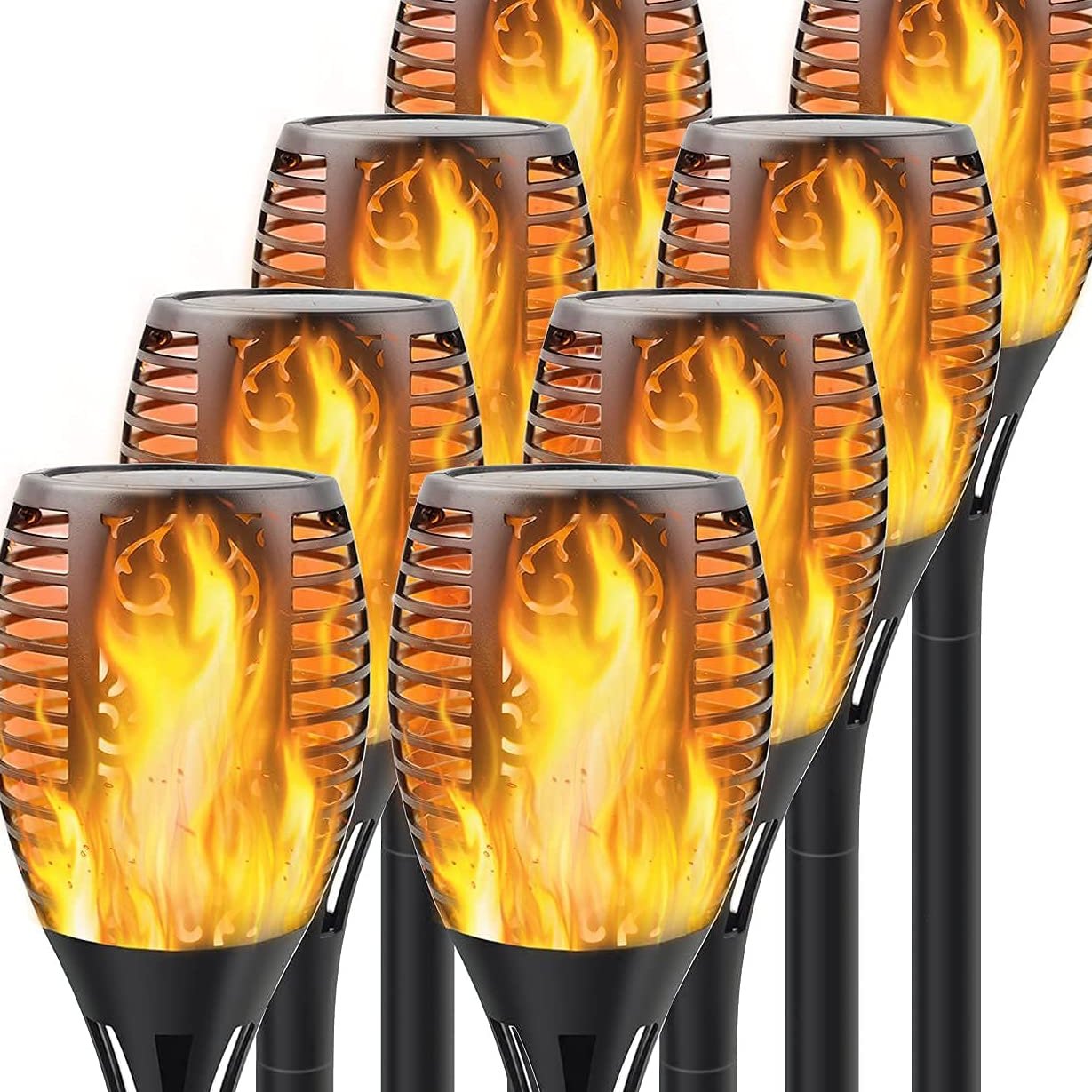 Solar tiki torch lights with flickering flame effect in a backyard